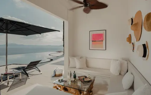 Stylish outdoor lounge with sea views and infinity pool, blending comfort and Mediterranean charm.