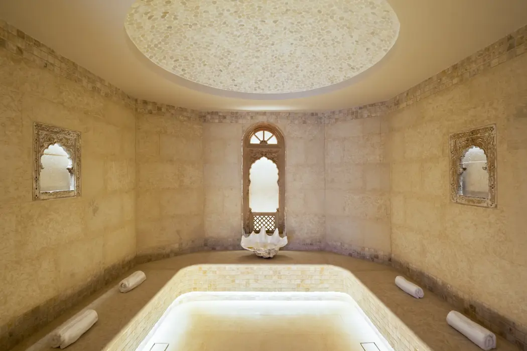 Serene spa room with soft lighting, natural stone finishes, and a peaceful atmosphere for total relaxation.
