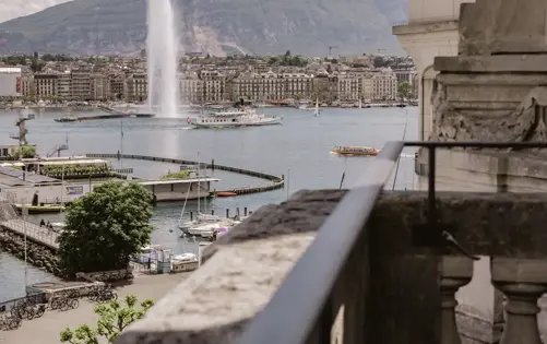 Serene lakeside view framed by elegant architecture, where water, city, and sky meet in perfect harmony.